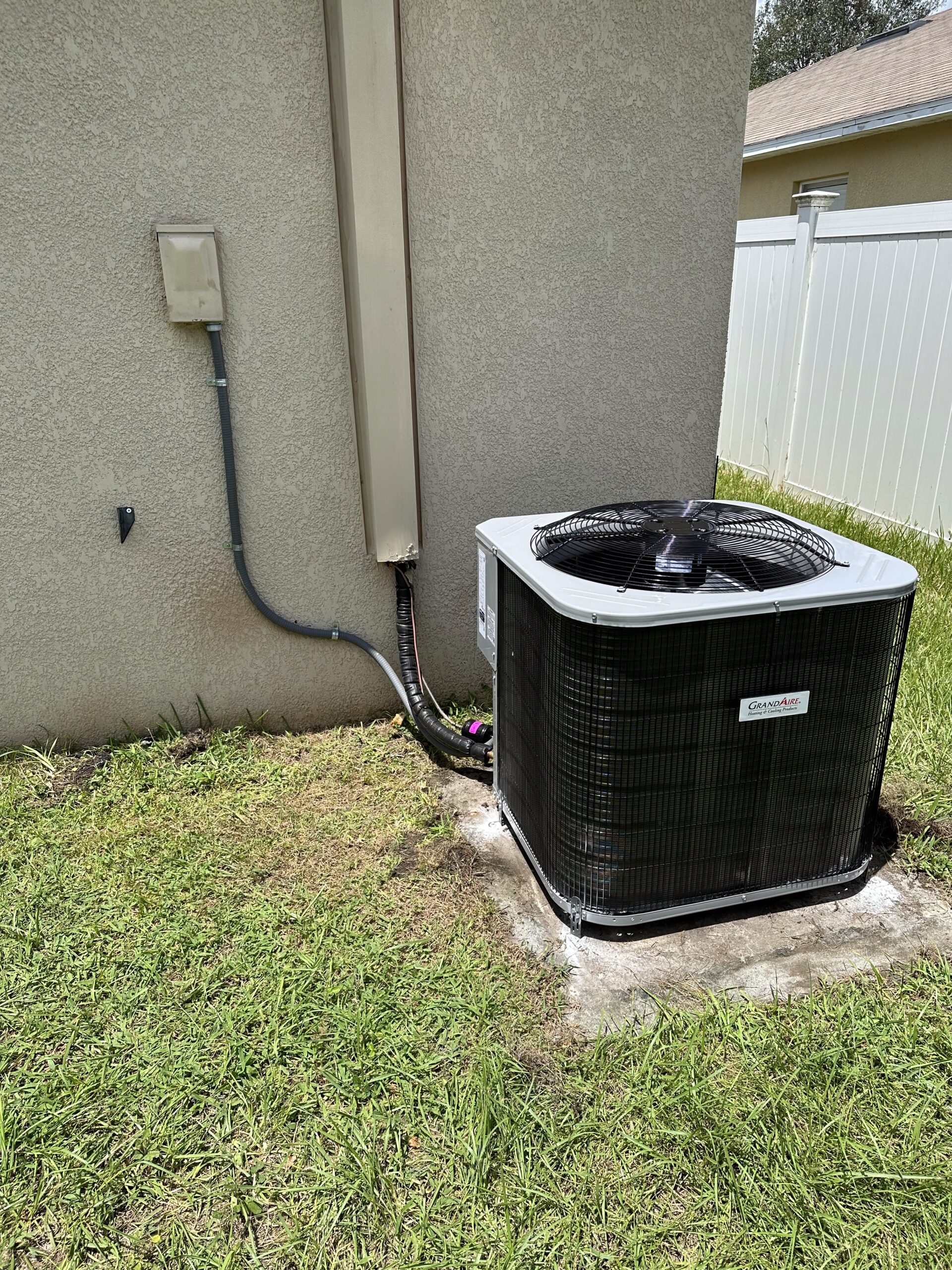 HVAC technician performing professional AC maintenance on a residential air conditioning unit