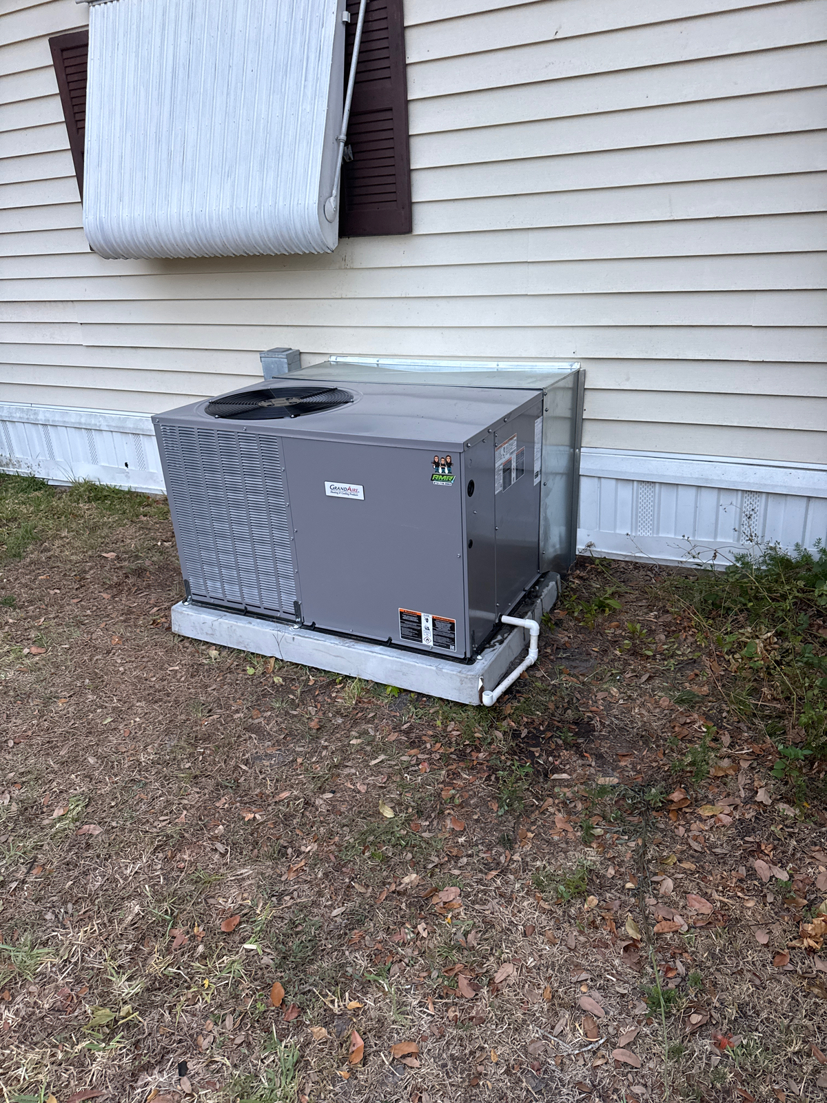 Technician inspecting an air conditioner experiencing Zephyrhills AC short cycling during hot and humid July weather.