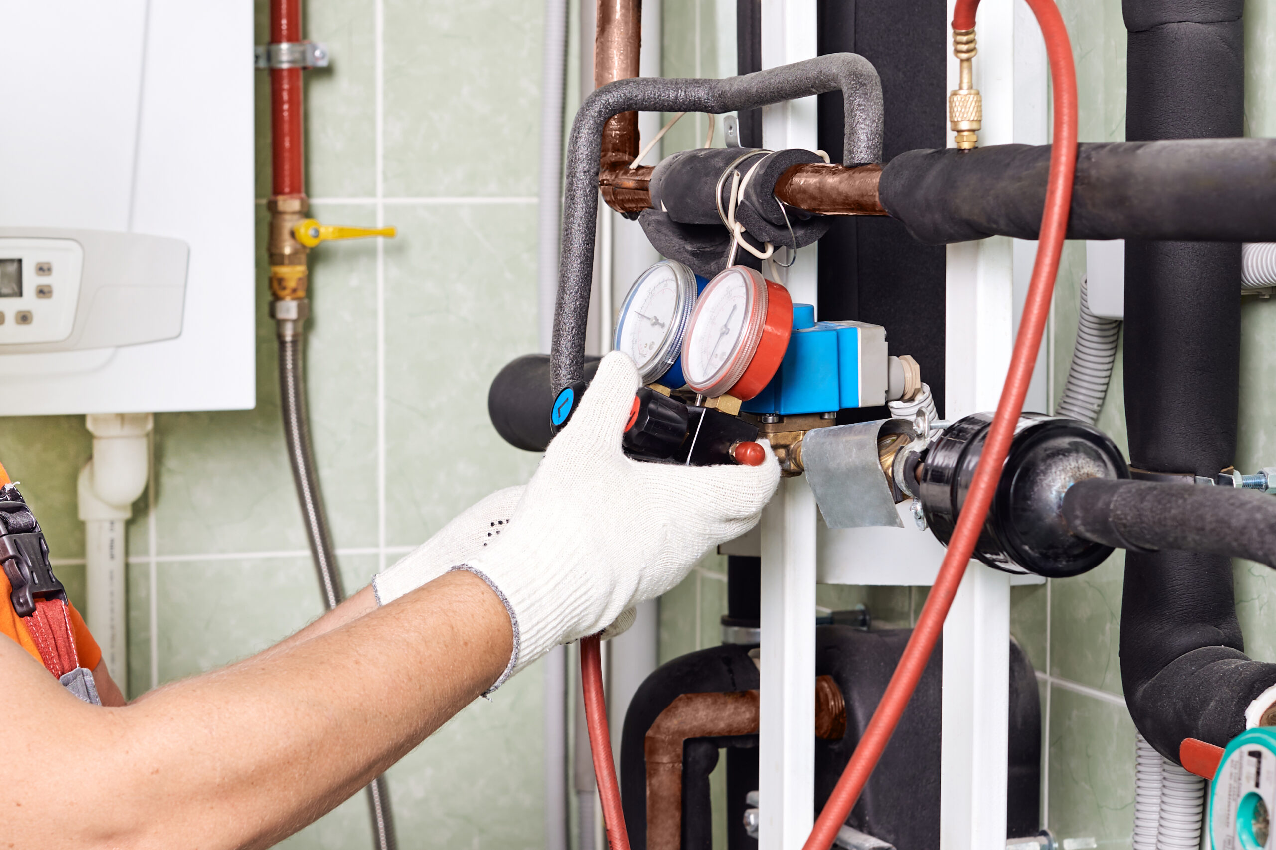 Technician performing heating system troubleshooting after detecting early warning signs of a heating system issue